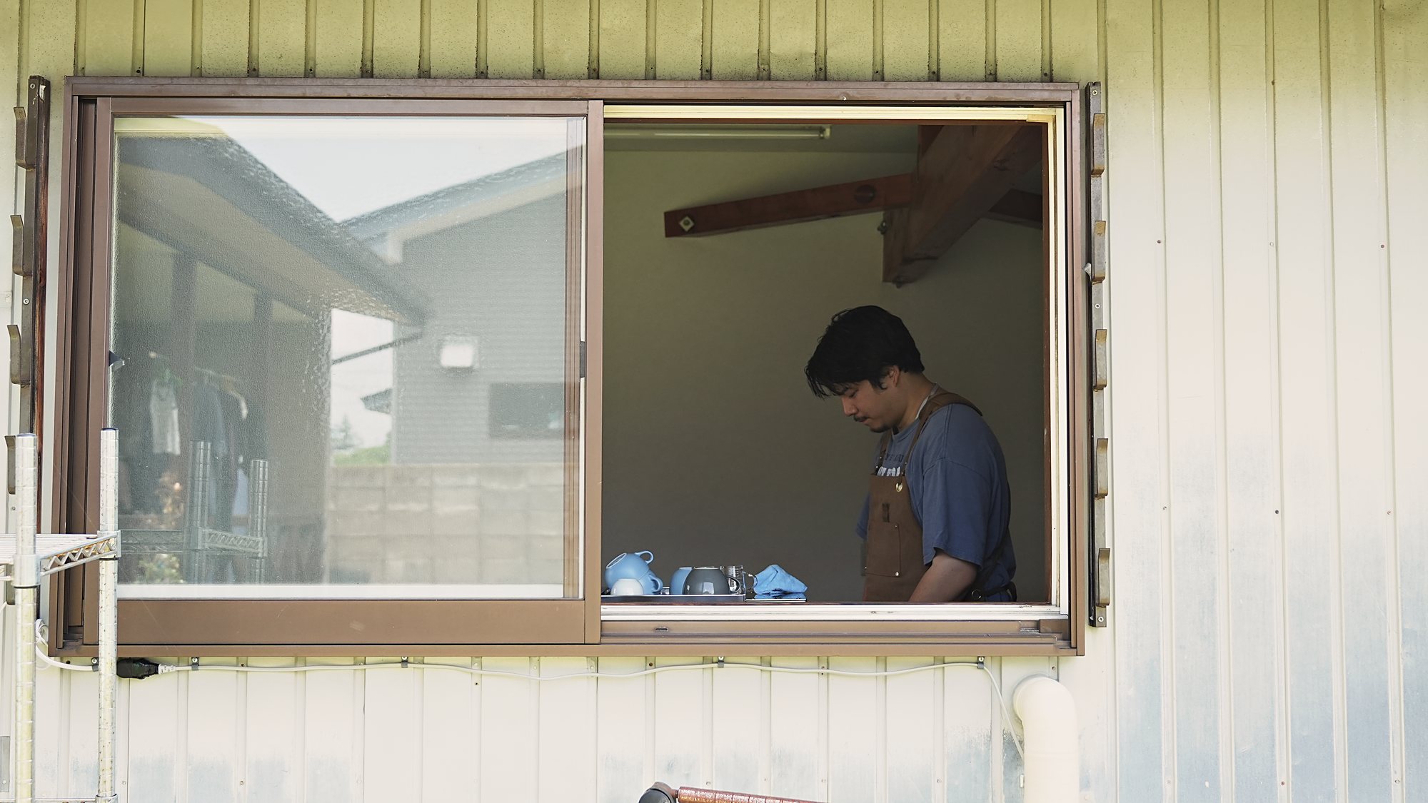 窓越しに見える焙煎所の作業風景